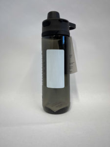 A translucent gray water bottle with a black lid and a light gray label on its side. A tag is attached to the bottle's handle.